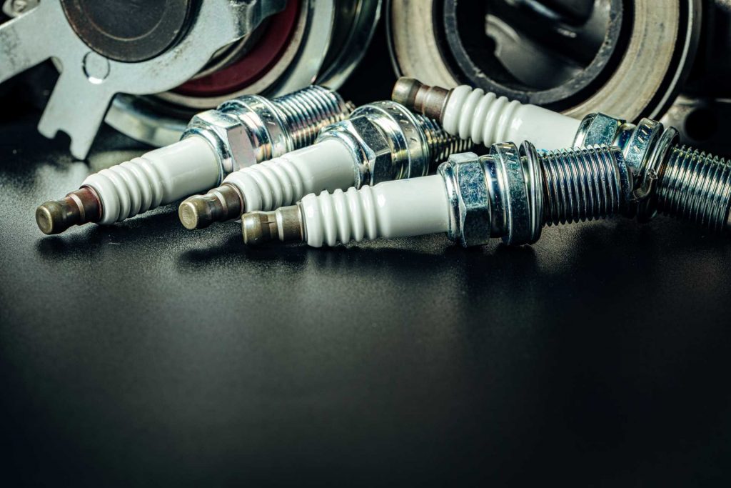 service your car, spark plugs on ground
