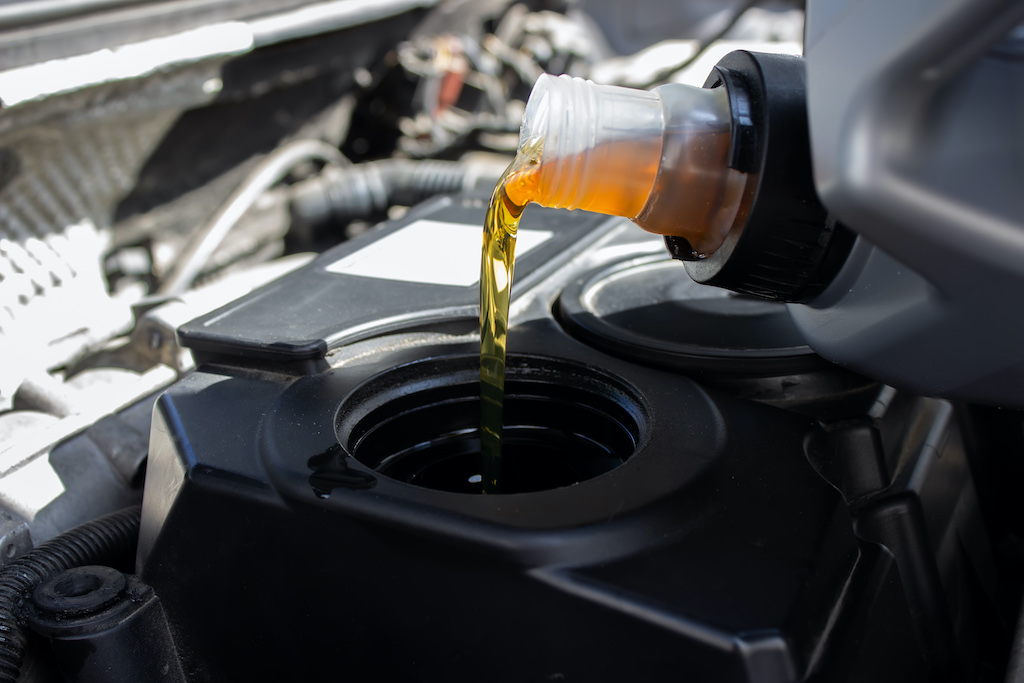 Car engine oil types, pouring engine oil.